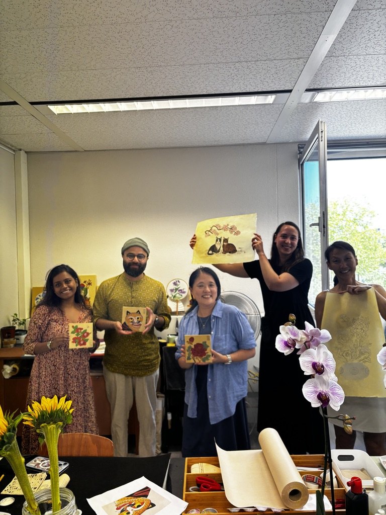 Students showing finished paintings after class